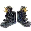 Foto de um(a) Antigo Cerra Livros Escultura De Galo Porcelana Art Deco, da categoria de Apoio para livros. Antigo e grande cerra livros em porcelana artística com figuras de galos, ricamente pintados à mão, e filetes em ouro.... Vendido no marketplace Trésors.