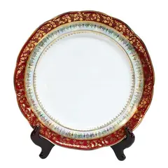 Foto de um(a) Prato ornamental em porcelana Schmidt, da categoria de Pratos Decorativos. Prato ornamental em porcelana branca com borda decorada e perolada, na tonalidade bordô e farta douração. Da manufatura... Vendido no marketplace Trésors.
