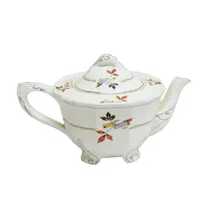 Foto de um(a) Bule para chá em porcelana inglesa, da categoria de Bules. Suntuoso bule inglês para chá em louça na tonalidade creme, corpo arredondado com base em 4 pés ornamentados, tampa com pega... Vendido no marketplace Trésors.