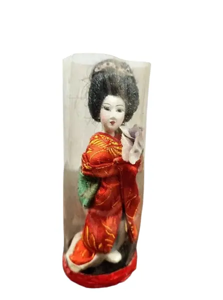 Foto de um(a) Pequena Gueixa Japonesa, Década de 1960, da categoria de Modelos e estatuetas. Pequena gueixa com seu quimono original dos anos 1960. Ainda com a embalagem. A: 12 cm / Diâmetro: 4,6 cm / Peso: 38 g. Vendido no marketplace Trésors.