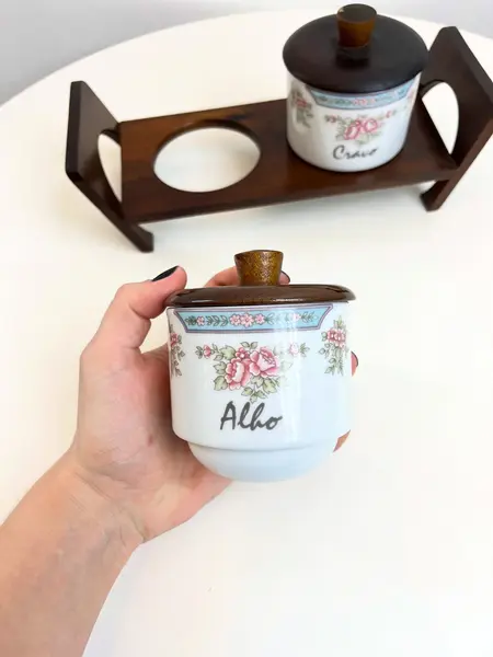 Foto de um(a) ​Porta temperos em porcelana Schmidt, da categoria de Garrafas, potes e jarros. Porta temperos em porcelana Schmidt estampada com tampa e suporte e madeira. Leves marcas do tempo e uso. Medidas totais:... Mostrado de uma perspectiva diferente. Vendido no marketplace Trésors.