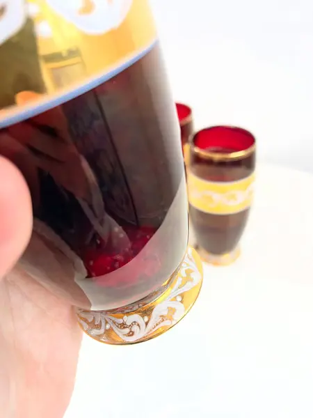 Foto de um(a) ​Trio de copos altos de vidro da década de 50, da categoria de Copos. Trio de copos altos de vidro da década de 50, pintados em bordô, dourado e branco. Marcas do tempo e uso e um com mínimo... Mostrado de uma perspectiva diferente. Vendido no marketplace Trésors.