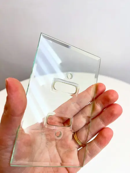 Foto de um(a) ​Espelho de tomada em cristal bisotê, da categoria de Metais, louças e acessórios. Espelho de tomada em cristal bisotê sem parafusos. Mínimos bicados nos cantinhos. Medidas: 12,5x8cm. Mostrado de uma perspectiva diferente. Vendido no marketplace Trésors.