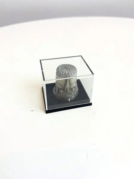 Foto de um(a) ​Dedal em chumbo na caixinha de acrílico, da categoria de Outros colecionáveis. Dedal em chumbo na caixinha de acrílico. Souvenir inglês. Medidas caixinha: 4x3,5cm. Mostrado de uma perspectiva diferente. Vendido no marketplace Trésors.