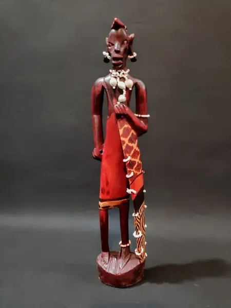 Foto de um(a) Escultura Africana Anos 80, da categoria de Escultura. Escultua africana em madeira policromada com missangas e sementes, década de 1980. A: 30 cm / L: 6,5 cm / P: 4 cm Peso: 248 g. Mostrado de uma perspectiva diferente. Vendido no marketplace Trésors.