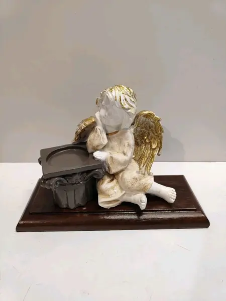 Foto de um(a) Castiçal Anjo em Resina Italiana e Imbuia, Década de 1980, da categoria de Castiçais. Castiçal anjo em resina italiana, com bata envelhecida, asas e cabelo com folha de ouro, coluna corintia serve como castiçal... Mostrado de uma perspectiva diferente. Vendido no marketplace Trésors.