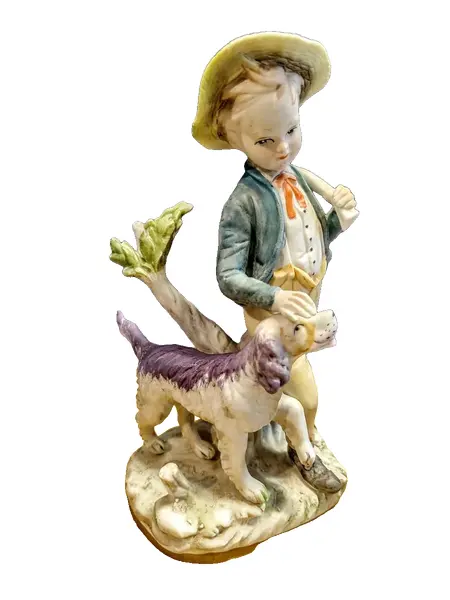 Foto de um(a) Biscuit Italiano Menino e Cão, Década de 1980, da categoria de Modelos e estatuetas. Biscuit italiano policromada dos anos 1980. A: 23 cm / L: 11 cm / P: 15 cm / Peso: 650 g. Vendido no marketplace Trésors.
