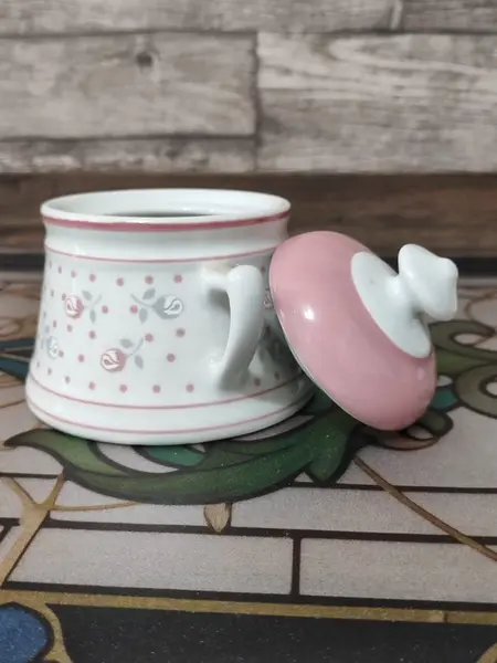 Foto de um(a) Bule e Açucareiro Porcelana Real, Década de 1990, da categoria de Bules. Combo com bule e açucareiro em porcelana branca e estampa de flores em rosa e cinza. Bule com trava na tampa e tranca pingo.... Mostrado de uma perspectiva diferente. Vendido no marketplace Trésors.