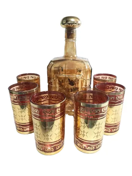 Foto de um(a) Conjunto Indiano Anos 70, da categoria de Jogos de taças e copos. Conjunto indiano e folheado a ouro, 6 copos em vidro (made in korea) e 1 garrafa em cristal âmbar com pintura floral para... Vendido no marketplace Trésors.