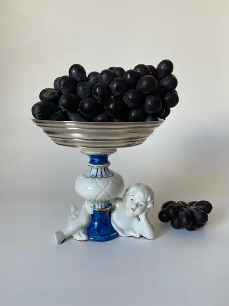Foto de um(a) Fruteira de porcelana, da categoria de Travessas e tigelas. Pequena fruteira em porcelana e metal. Apresenta um restauro no pé. Mede: 13 x 14cm. Mostrado de uma perspectiva diferente. Vendido no marketplace Trésors.