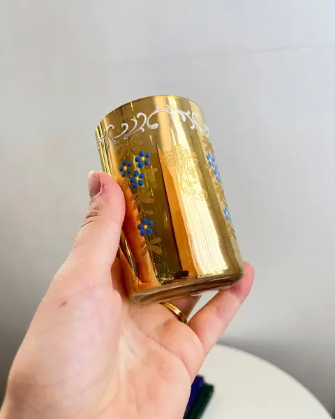 Foto de um(a) Copo em fino vidro furta cor, da categoria de Copos. Copo em fino vidro furta cor com pinturas a mão em alto relevo e douração no fundo. Década de 40/50. Apresenta leves... Mostrado de uma perspectiva diferente. Vendido no marketplace Trésors.