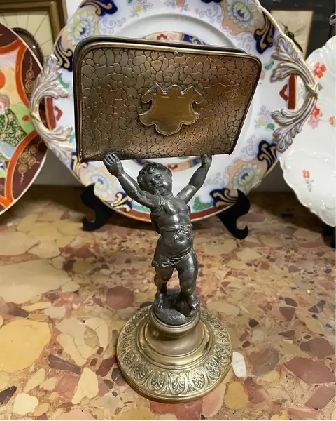 Foto de um(a) Antiga Escultura Porta Carta Bronze E Metal Prateado Wmf, da categoria de Escultura. WMF. Antigo e raro porta carta em metal prateado e dourado, com figura de criança segurando as correspondências. Da renomada... Mostrado de uma perspectiva diferente. Vendido no marketplace Trésors.