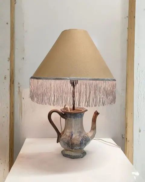 Foto de um(a) Luminária Bule Inglês, da categoria de Abajures. Bule inglês antigo sem restauro transformado em luminária, interruptor no próprio bocal, cúpula em tecido com franja de seda... Mostrado de uma perspectiva diferente. Vendido no marketplace Trésors.