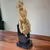 Foto de um(a) Escultura Italiana em terracota menina com cachorro, da categoria de Escultura. Rara e lúdica escultura em terracota ´´ Menino com cachorro`` em coluna de madeira ebonizada.Manufatura Milan... Mostrado de uma perspectiva diferente. Vendido no marketplace Trésors.