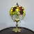 Foto de um(a) Abajur opalina e bronze, da categoria de Abajures. Lindo abajur opalina de bronze pintado de dourado, com cúpula estilo tiffany. Medidas: Altura 38 cm x diâmetro cúpula 20 cm... Mostrado de uma perspectiva diferente. Vendido no marketplace Trésors.
