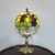 Foto de um(a) Abajur opalina e bronze, da categoria de Abajures. Lindo abajur opalina de bronze pintado de dourado, com cúpula estilo tiffany. Medidas: Altura 38 cm x diâmetro cúpula 20 cm... Mostrado de uma perspectiva diferente. Vendido no marketplace Trésors.