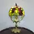 Foto de um(a) Abajur opalina e bronze, da categoria de Abajures. Lindo abajur opalina de bronze pintado de dourado, com cúpula estilo tiffany. Medidas: Altura 38 cm x diâmetro cúpula 20 cm... Mostrado de uma perspectiva diferente. Vendido no marketplace Trésors.