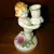 Foto de um(a) Antigo Castiçal Criança Em Porcelana Alemã Von Schierholz, da categoria de Castiçais. Von Schierholz. Antigo e pequeno castiçal, feito e pintado à mão, em porcelana artística alemã. Peça muito delicada e com... Mostrado de uma perspectiva diferente. Vendido no marketplace Trésors.