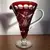 Foto de um(a) Antiga Jarra Em Cristal Baccarat Cor Vermelho Rubi Lapidado, da categoria de Jarros. Antiga jarra em cristal Baccarat na cor vermelho rubi, ricamente lapidado à mão, como uma jóia.Medidas 24x22cm. Mostrado de uma perspectiva diferente. Vendido no marketplace Trésors.