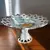 Foto de um(a) Antiga Delicada Fruteirinha Fenestrado Porcelana Alemã, da categoria de Travessas e tigelas. Delicada e pequena fruteira fenestrada em porcelana alemã, com linda decoração floral e filetes em ouro. Medidas 10x18cm. Mostrado de uma perspectiva diferente. Vendido no marketplace Trésors.