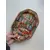 Foto de um(a) ​Bandeja em bambu estampado, da categoria de Travessas e tigelas. Bandeja em bambu estampado com detalhe em plástico dourado. Leves marcas do tempo e uso. Medidas: 26x18cm. Mostrado de uma perspectiva diferente. Vendido no marketplace Trésors.