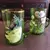 Foto de um(a) Antigas Canecas Murano Vidro Veneziano Mary Gregory Verde, da categoria de Canecas. Par de canecas em Murano veneziano, com linda pintura feita à mão com esmalte e ouro. Estilo Mary Gregory. Ambas em perfeito... Mostrado de uma perspectiva diferente. Vendido no marketplace Trésors.