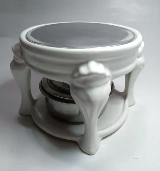Foto de um(a) Panela de Fondue com Rechaud em Porcelana, da categoria de Panelas. Panela de fondue em inox e suporte em porcelana. A: 24cm / Diâmetro: 16cm. Mostrado de uma perspectiva diferente. Vendido no marketplace Trésors.
