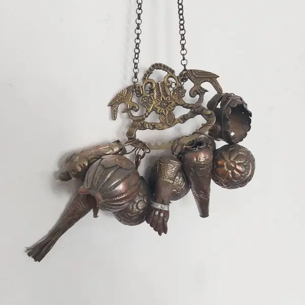 Foto de um(a) Penca de balangandã baiana em metal, da categoria de Objetos religiosos e espirituais. Antiga penca de balangandã baiana em metal com nove balangandãs diversos. O balangandã é um objeto de significado ritual... Mostrado de uma perspectiva diferente. Vendido no marketplace Trésors.
