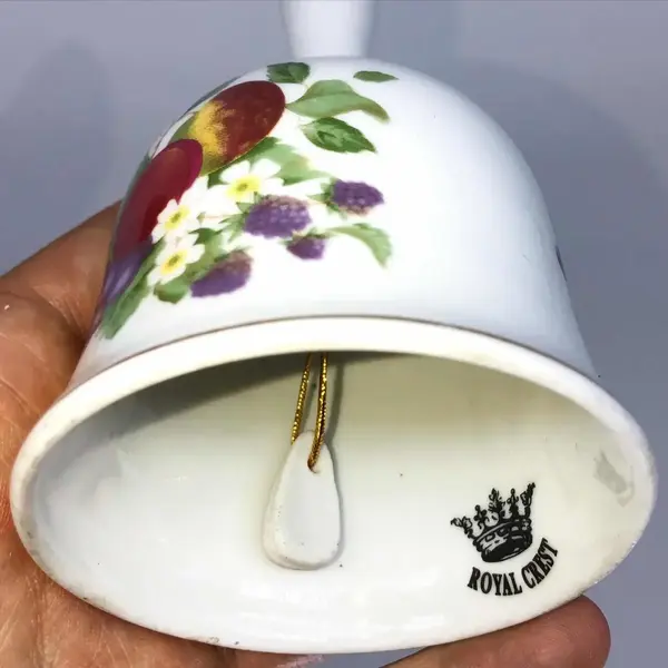 Foto de um(a) Antigo Sino Sineta De Mesa Porcelana Inglesa Royal Crest (Usado), da categoria de Outros objetos decorativos. Royal Crest. Lindo e decorativo sino em porcelana inglesa, com decoração de flores e frutas, e filetes em ouro. Badalo muito... Mostrado de uma perspectiva diferente. Vendido no marketplace Trésors.