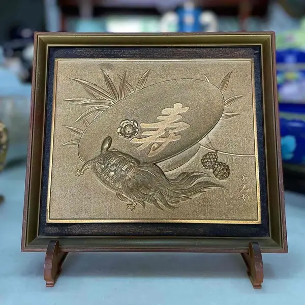 Foto de um(a) Antigo Raro Quadro De Mesa Japonês Caixa Oriental Minogame, da categoria de Objetos decorativos. Curioso quadro de mesa em metal dourado de excelente qualidade, lindo brilho natural e ótima fundição, com bastante riqueza... Mostrado de uma perspectiva diferente. Vendido no marketplace Trésors.