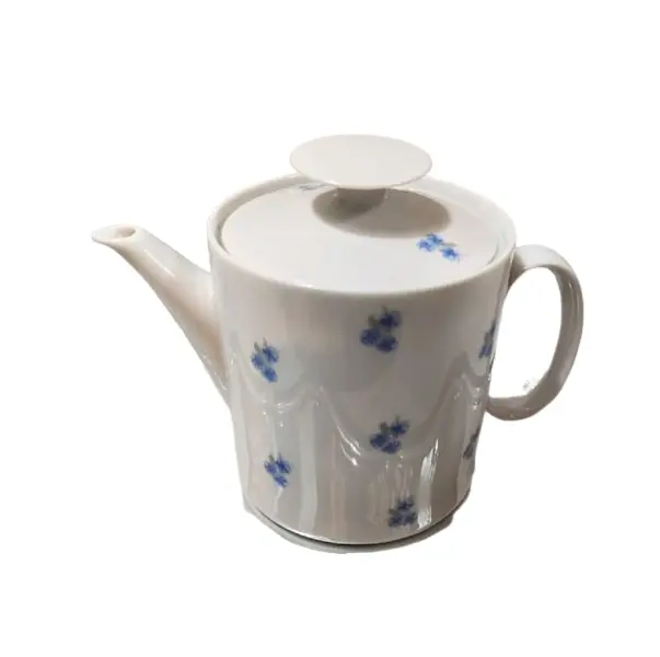 Foto de um(a) Bule de Leite Miosótis Anos 70, da categoria de Leiteira. Bule de leite em porcelana branca com miosótis em azul cobalto, década de 1970, sem marca do fabricante. A: 14 cm /... Vendido no marketplace Trésors.