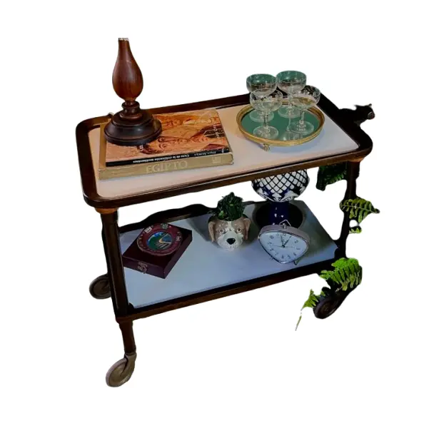 Foto de um(a) Carrinho de chá 60’s em Jacarandá, da categoria de Carrinhos de bar e auxiliares. Carrinho de chá da década de 60 em jacarandá, tampos retangulares em fórmica branca com uma alça em uma lateral torneada,... Vendido no marketplace Trésors.