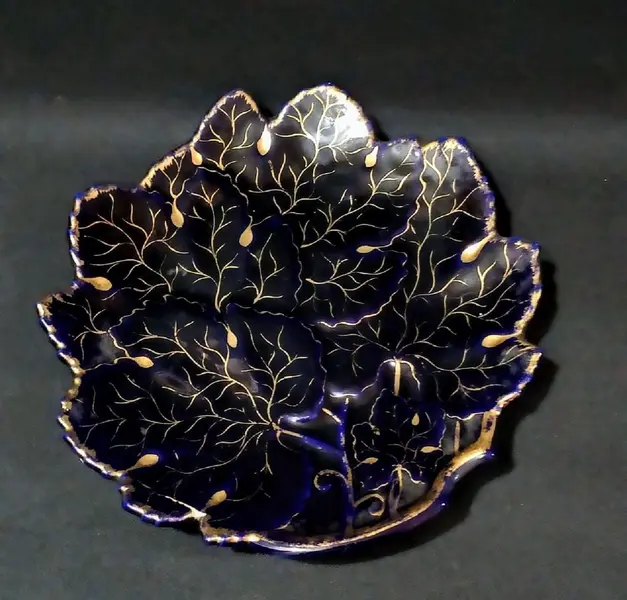 Foto de um(a) Prato Cobalto e Ouro ano 95, da categoria de Pratos Decorativos. Prato em porcelana em forma de folha na cor azul cobalto com ouro. Assinado: regina, 1995 Diâmetro 26 cm / A: 3 cm peso:... Mostrado de uma perspectiva diferente. Vendido no marketplace Trésors.