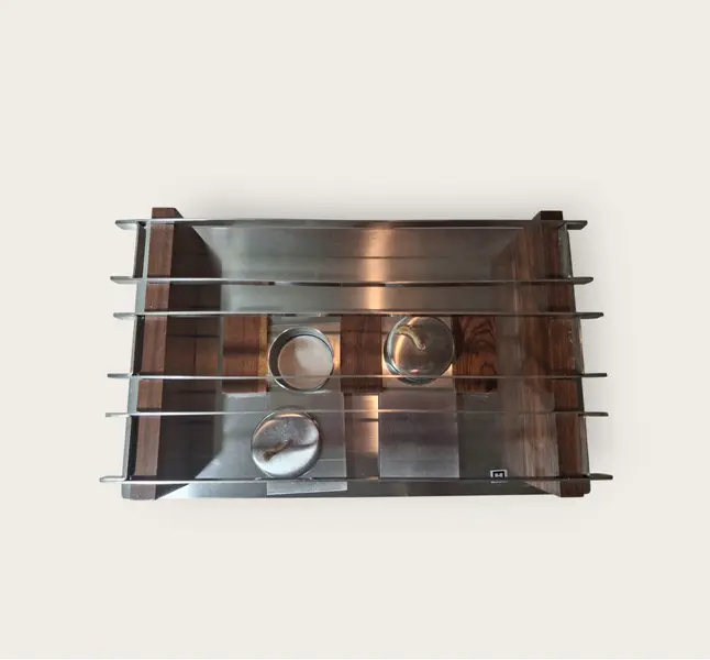 Foto de um(a) Rechaud de mesa, da categoria de Outros utensílios para servir. Peça utilitária de design consagrado dos anos 70. Em aço inox, marca HERCULES, base retangular, grelha em barras em aço e... Mostrado de uma perspectiva diferente. Vendido no marketplace Trésors.