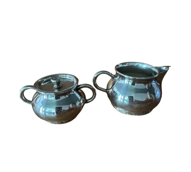 Foto de um(a) Açucareiro com tampa e Cremeira - tête-à-tête Wolff em Prata 90, da categoria de Conjuntos de café e chá. Conjunto clássico de mesa composto por açucareiro com tampa e cremeira, em prata 90 Wolff. Modelo de linhas arredondadas,... Vendido no marketplace Trésors.