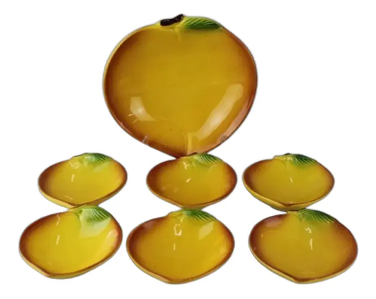 Foto de um(a) Conjunto para sobremesa, da categoria de Pratos. Conjunto de 7 peças em louça para sobremesa no formato de pêssego. Base amarela com borda em degradê quase marrom, pequena... Vendido no marketplace Trésors.