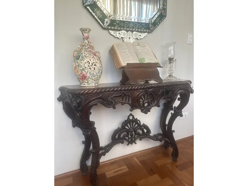 Foto de um(a) Console entalhado em madeira maciça – Estilo Clássico/Antiquário, da categoria de Aparadores e Buffet. Belíssimo console em madeira nobre maciça, ricamente entalhado à mão, com detalhes florais e arabescos em alto-relevo. A... Mostrado de uma perspectiva diferente. Vendido no marketplace Trésors.